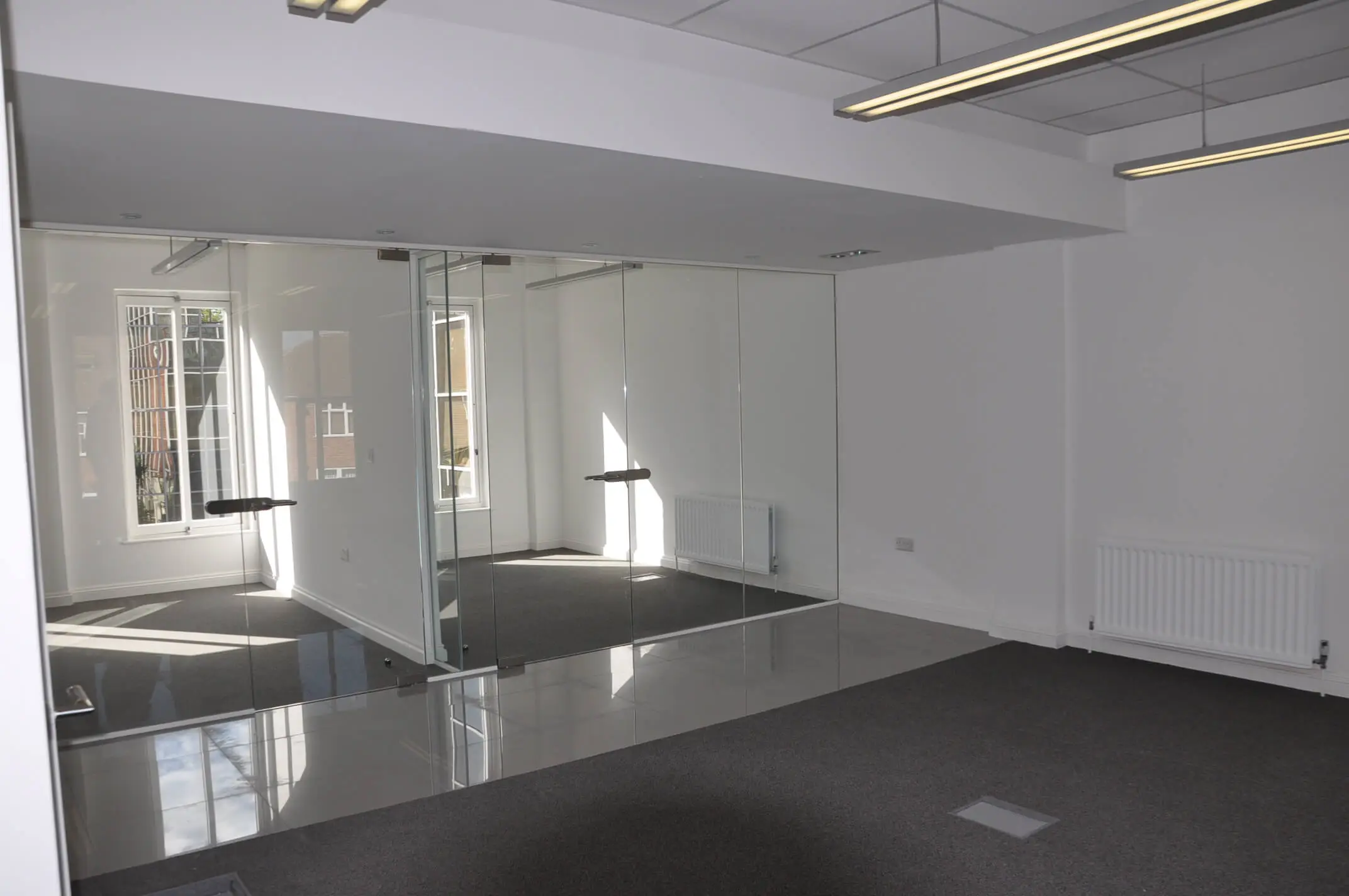 Office with frameless glass doors rooms