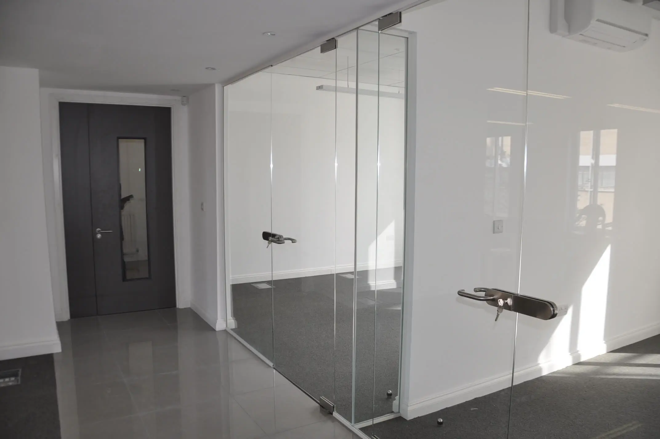 Office with frameless glass doors with lock