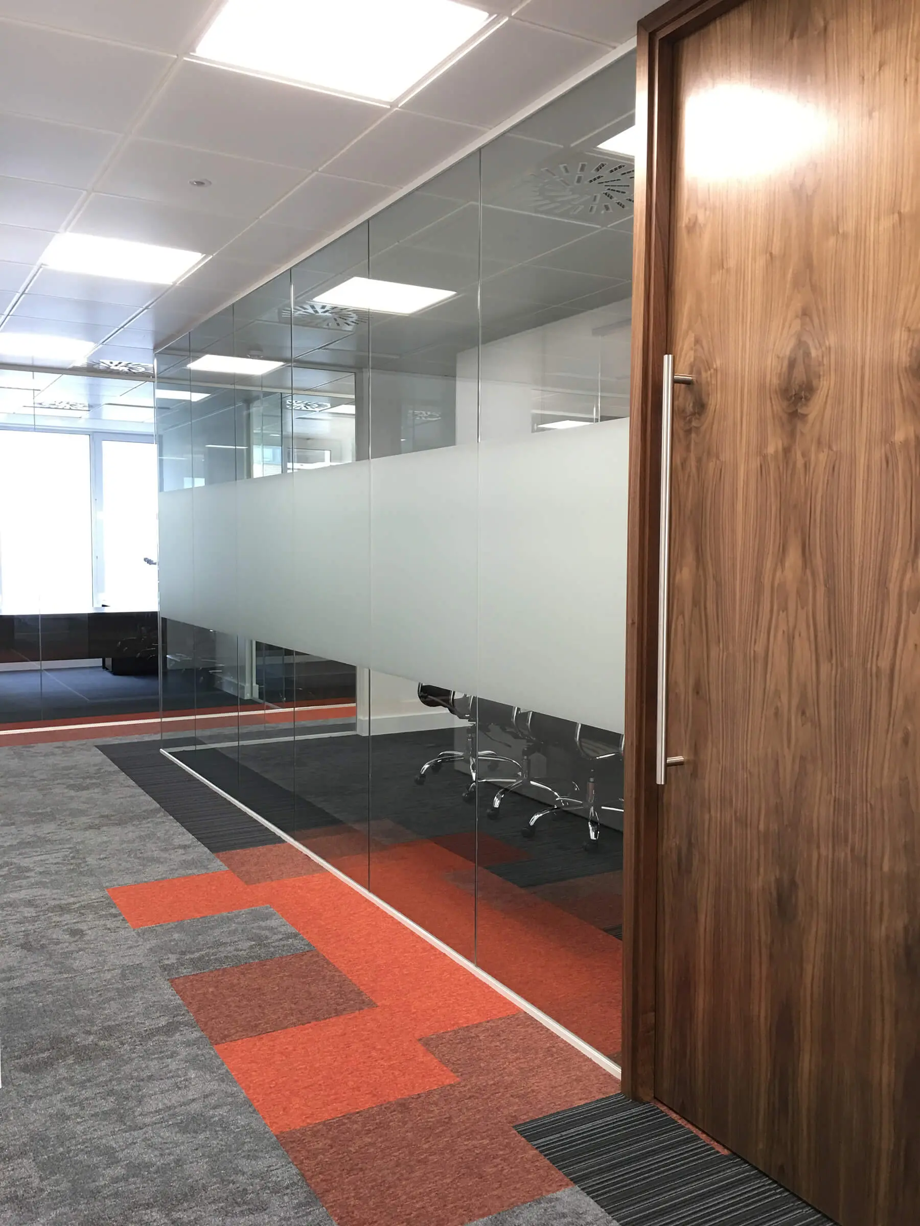 Office with glass walls and high solid band on it