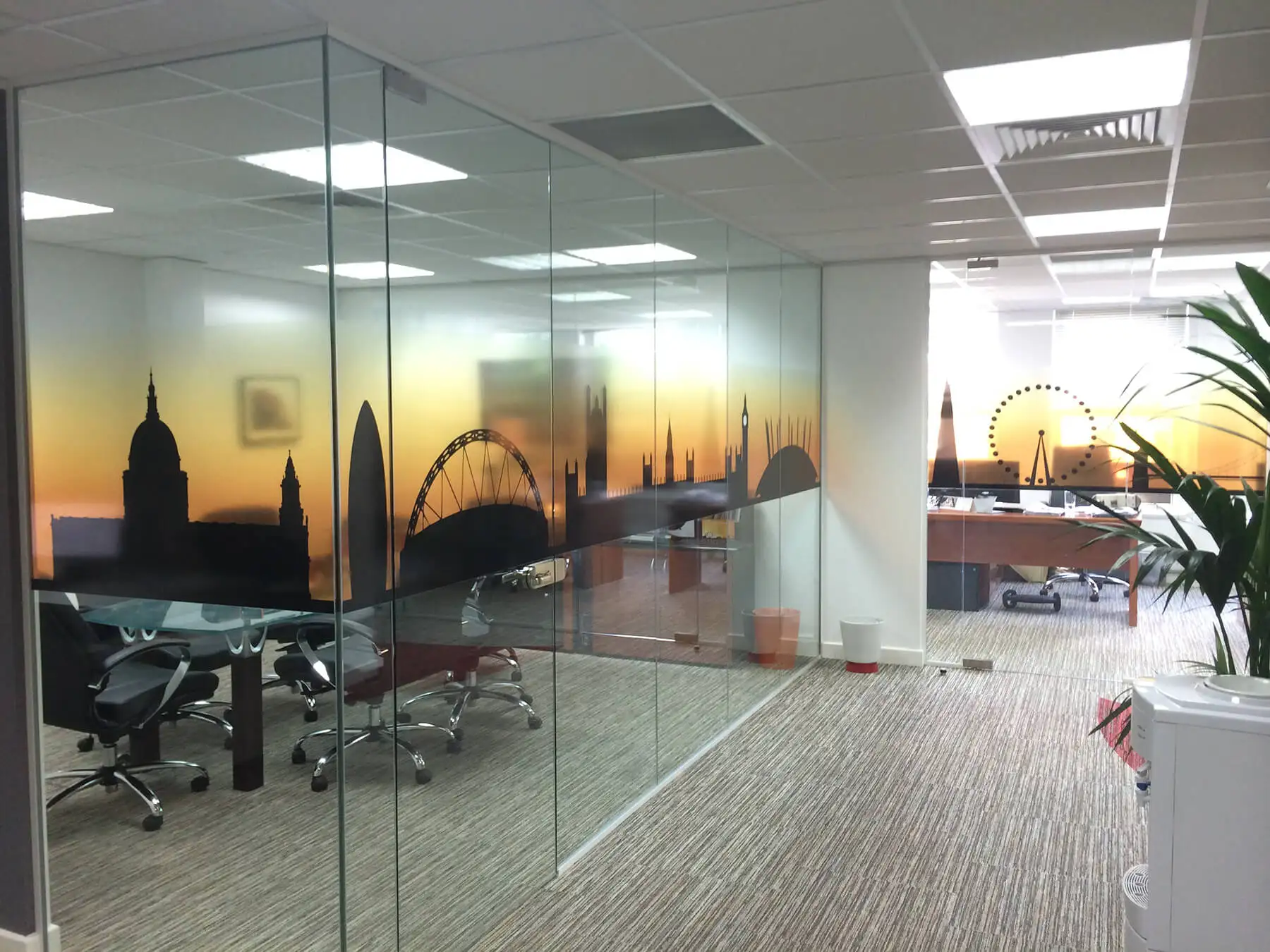 Office work space and meeting area space divided with glass partitions