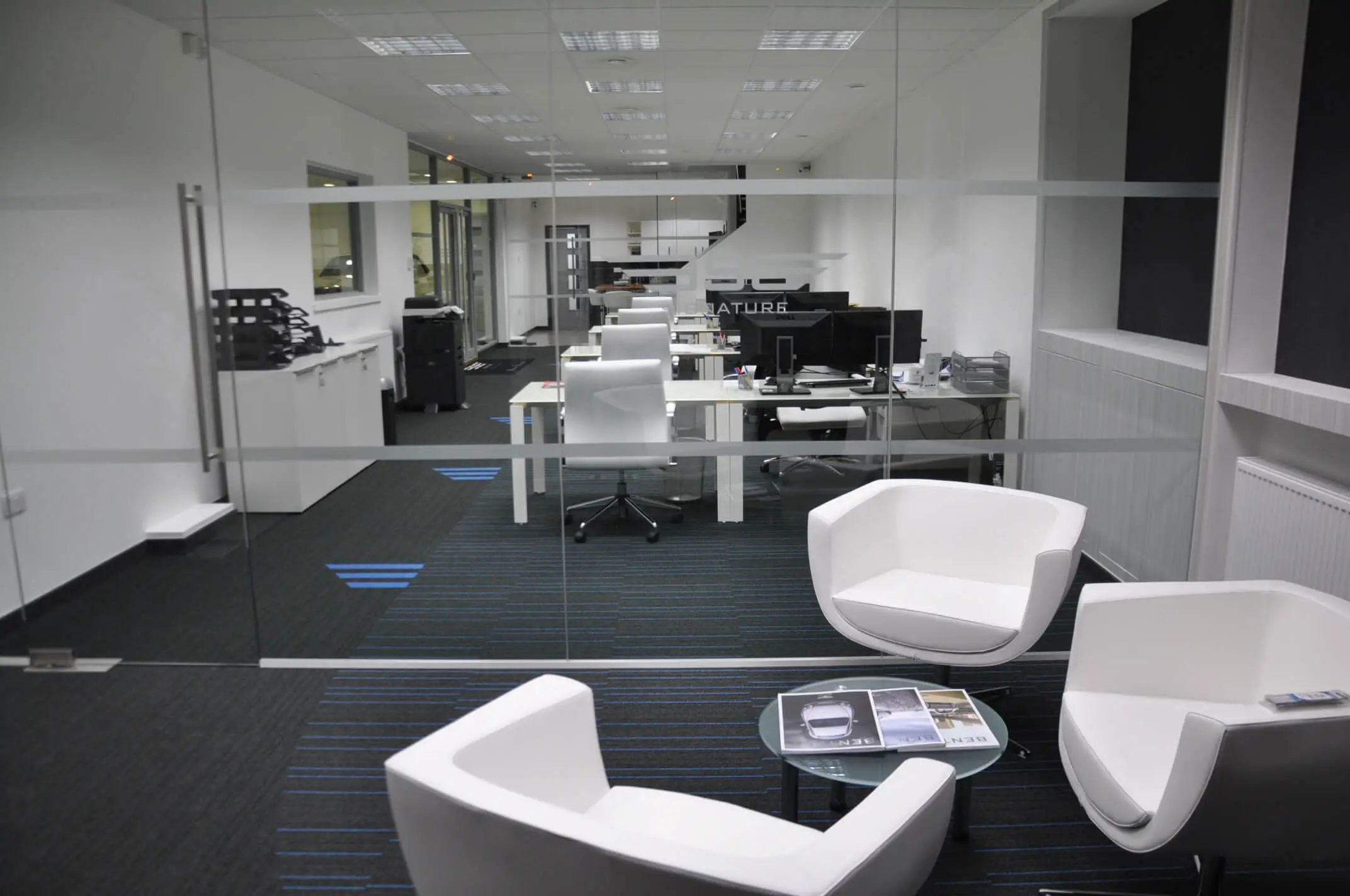 Offices work and breakout area spaces divided with glass partitions