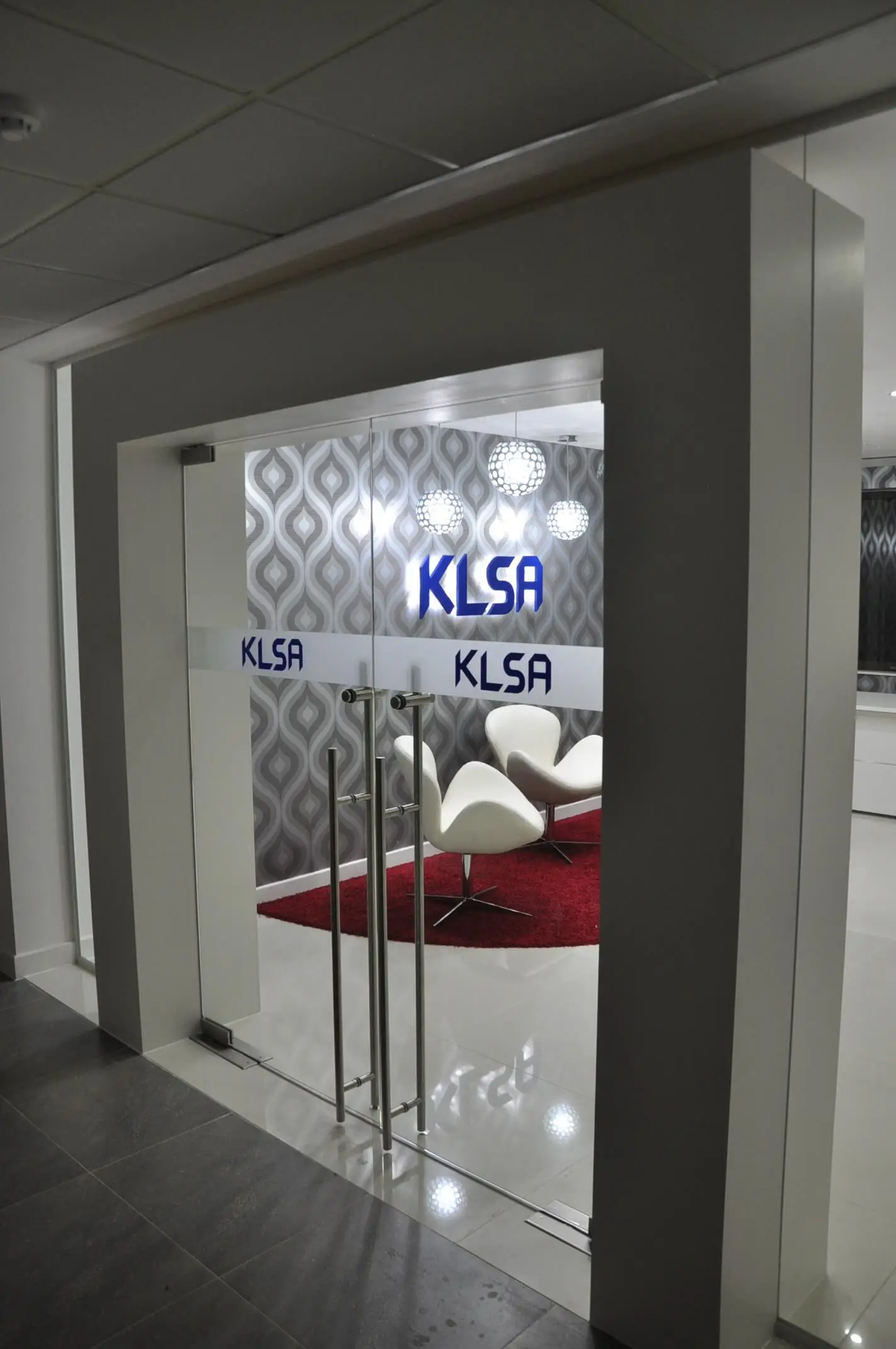 Office space with glass doors with logo cut out