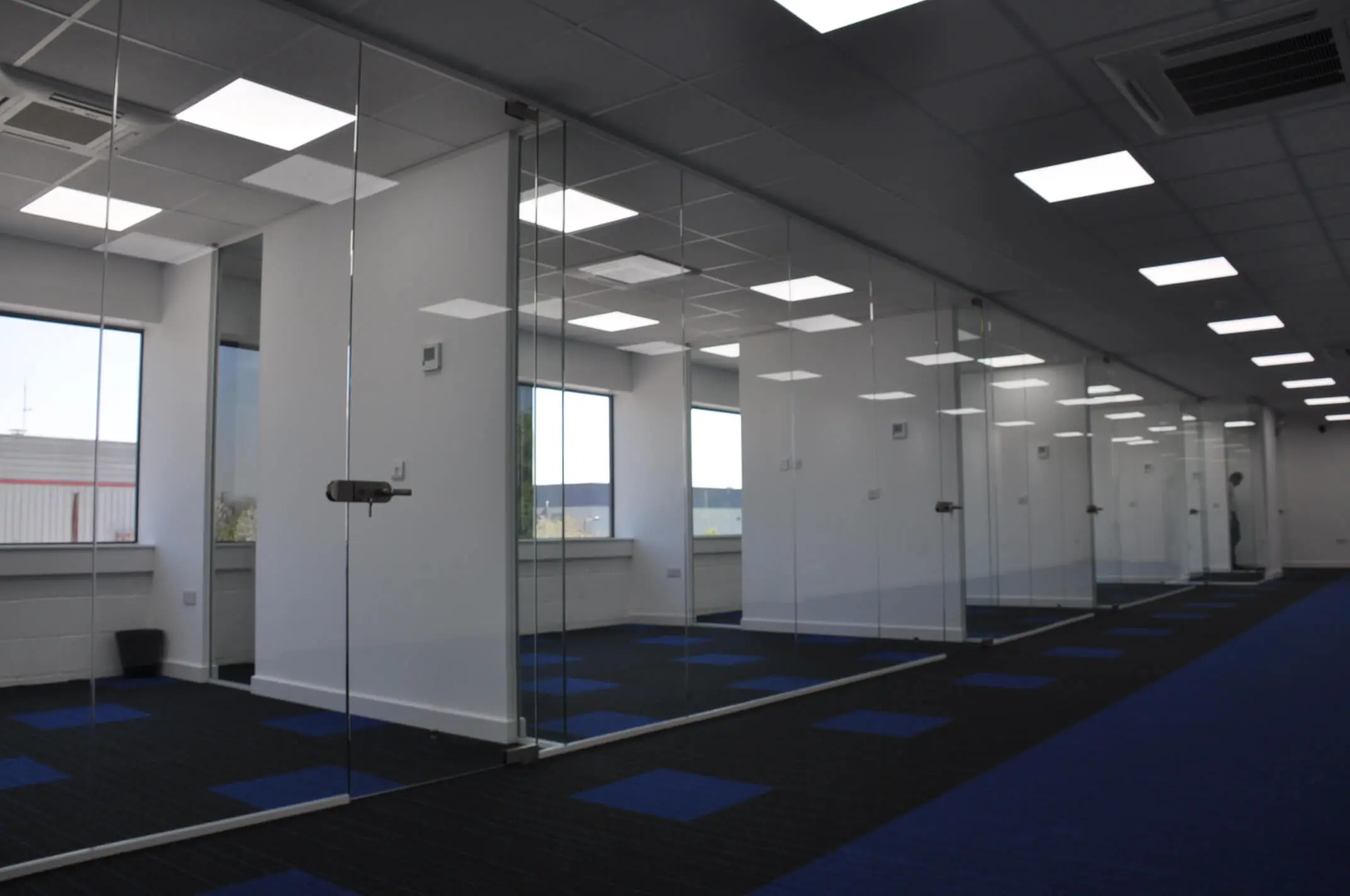 Single glazed frameless glass partitions with lock doors