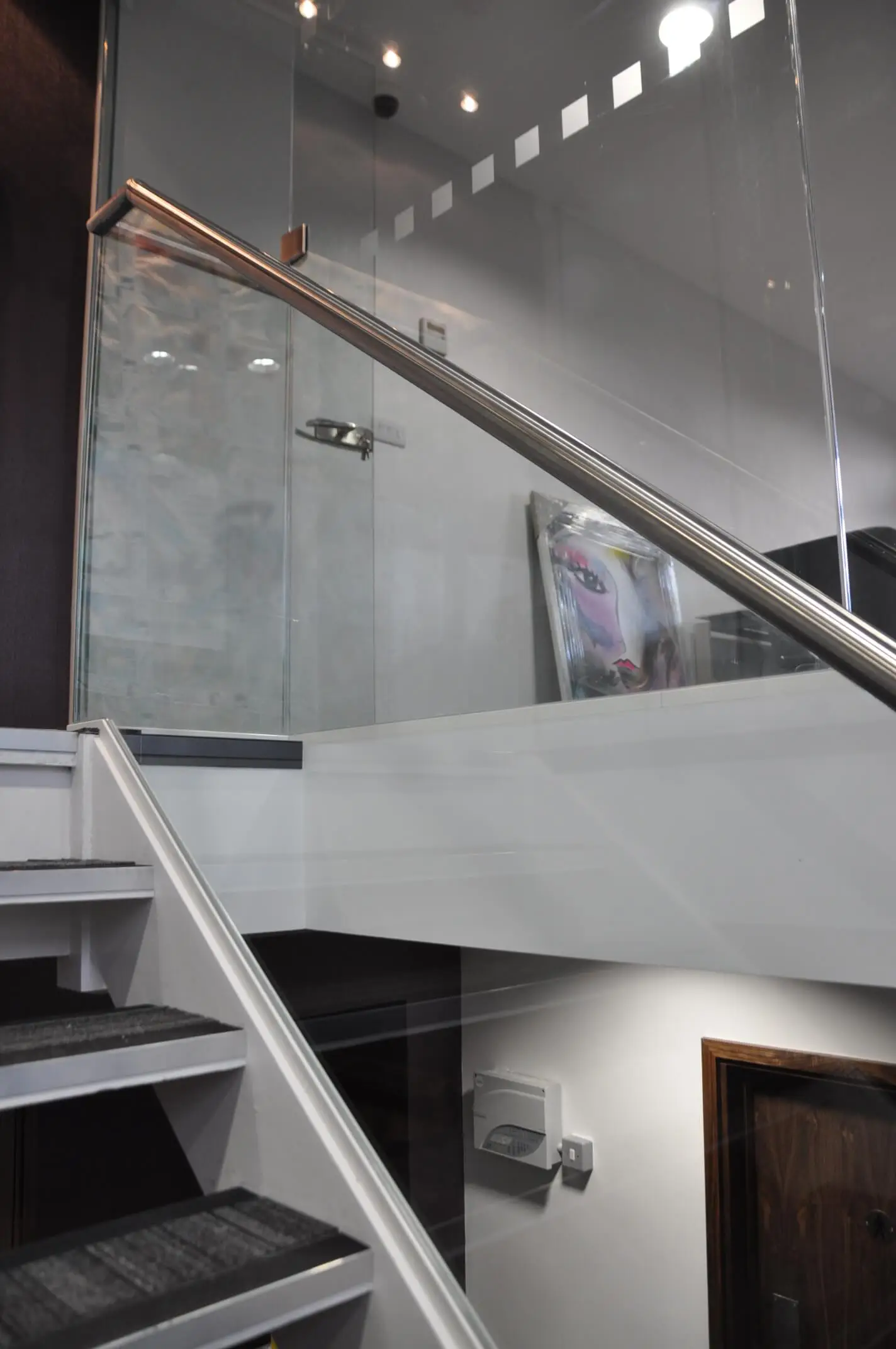 Single glazed glass partitions and glass stairs in office space