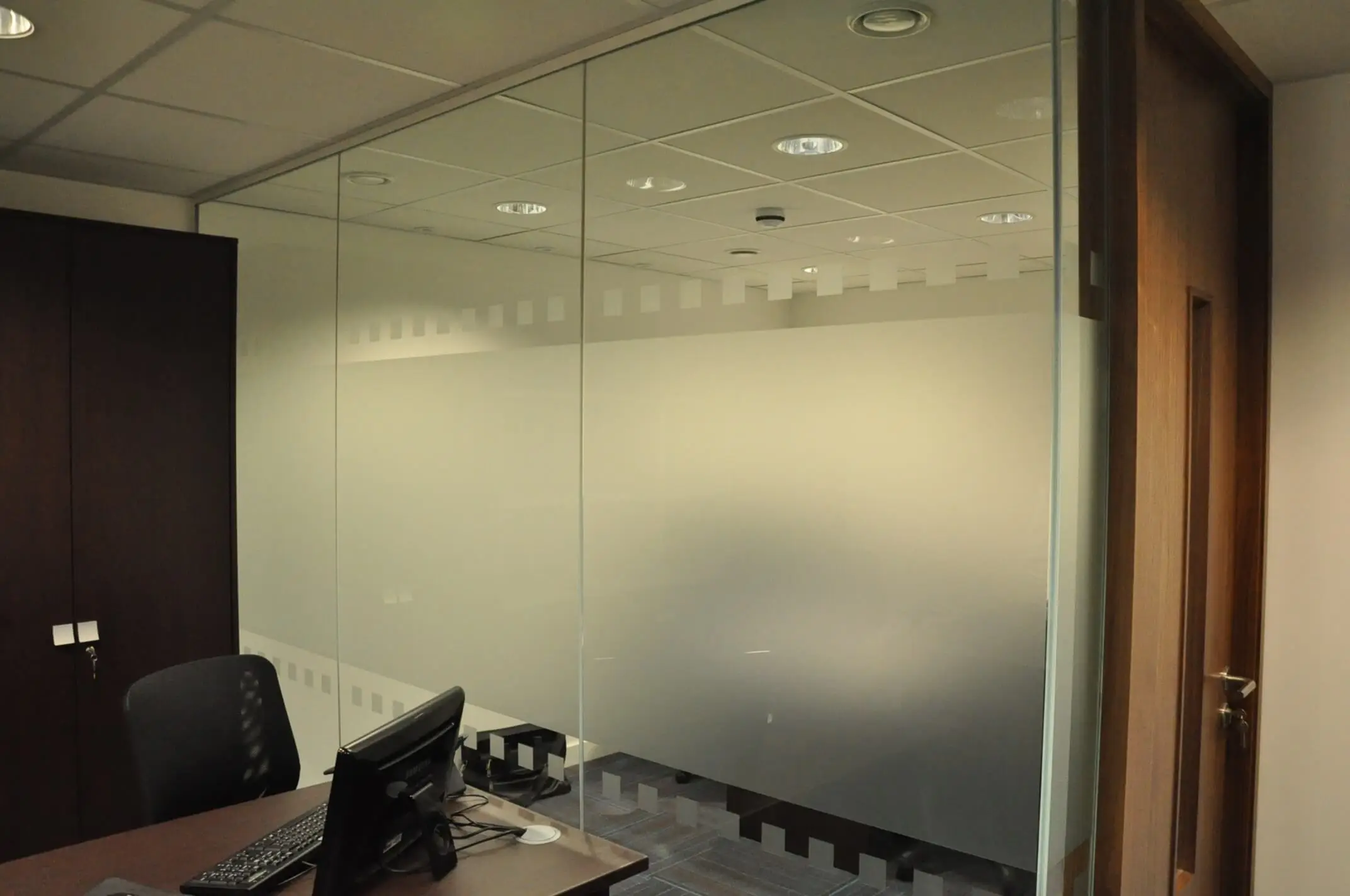 Single glazed manifested glass partitions in office