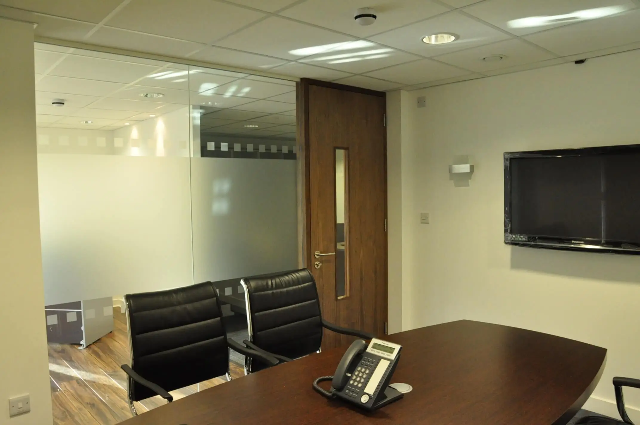 Small meeting room glass parttions with solid doors and manifestation