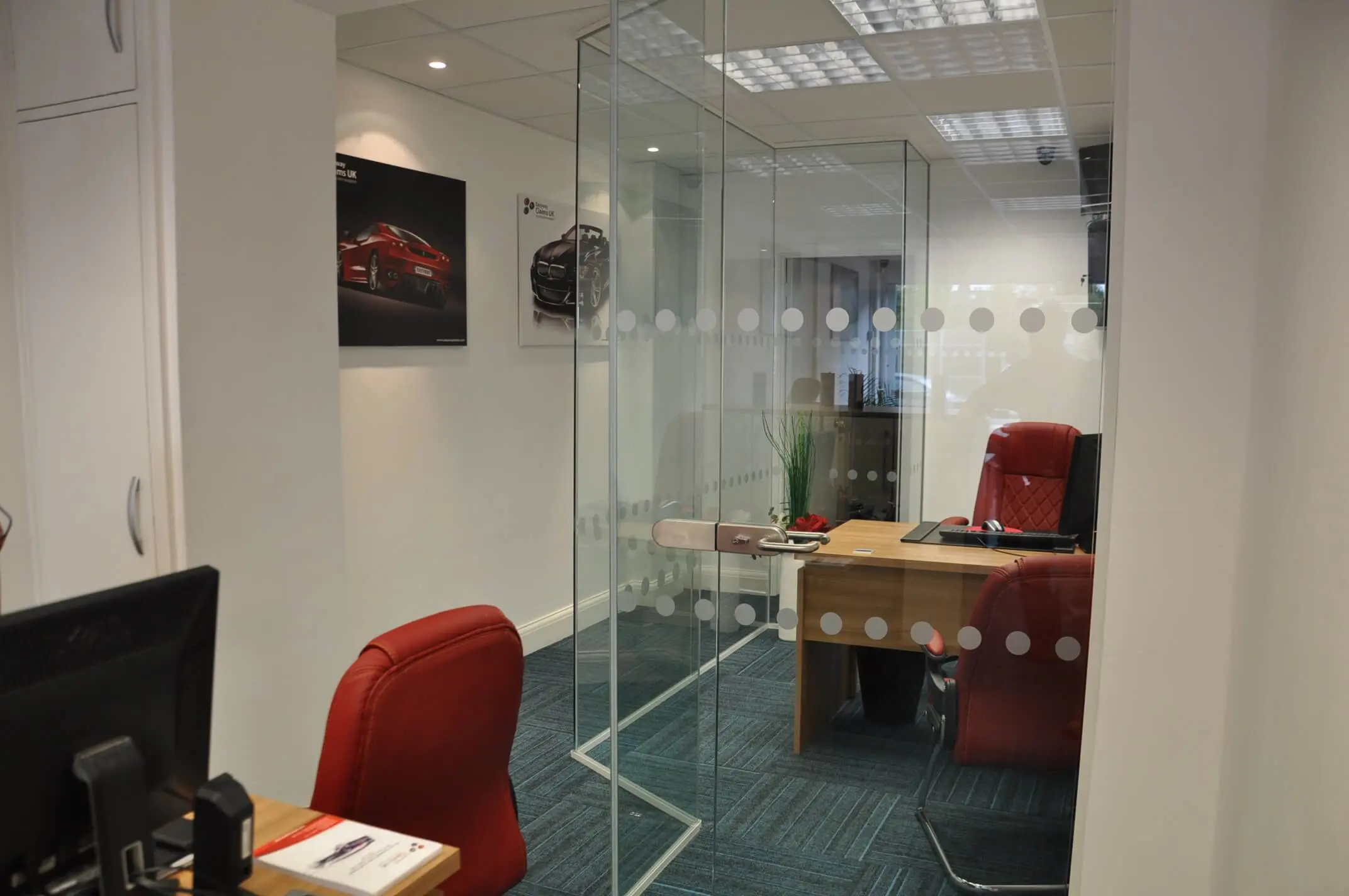 Small office space divided with dotted glass partitions