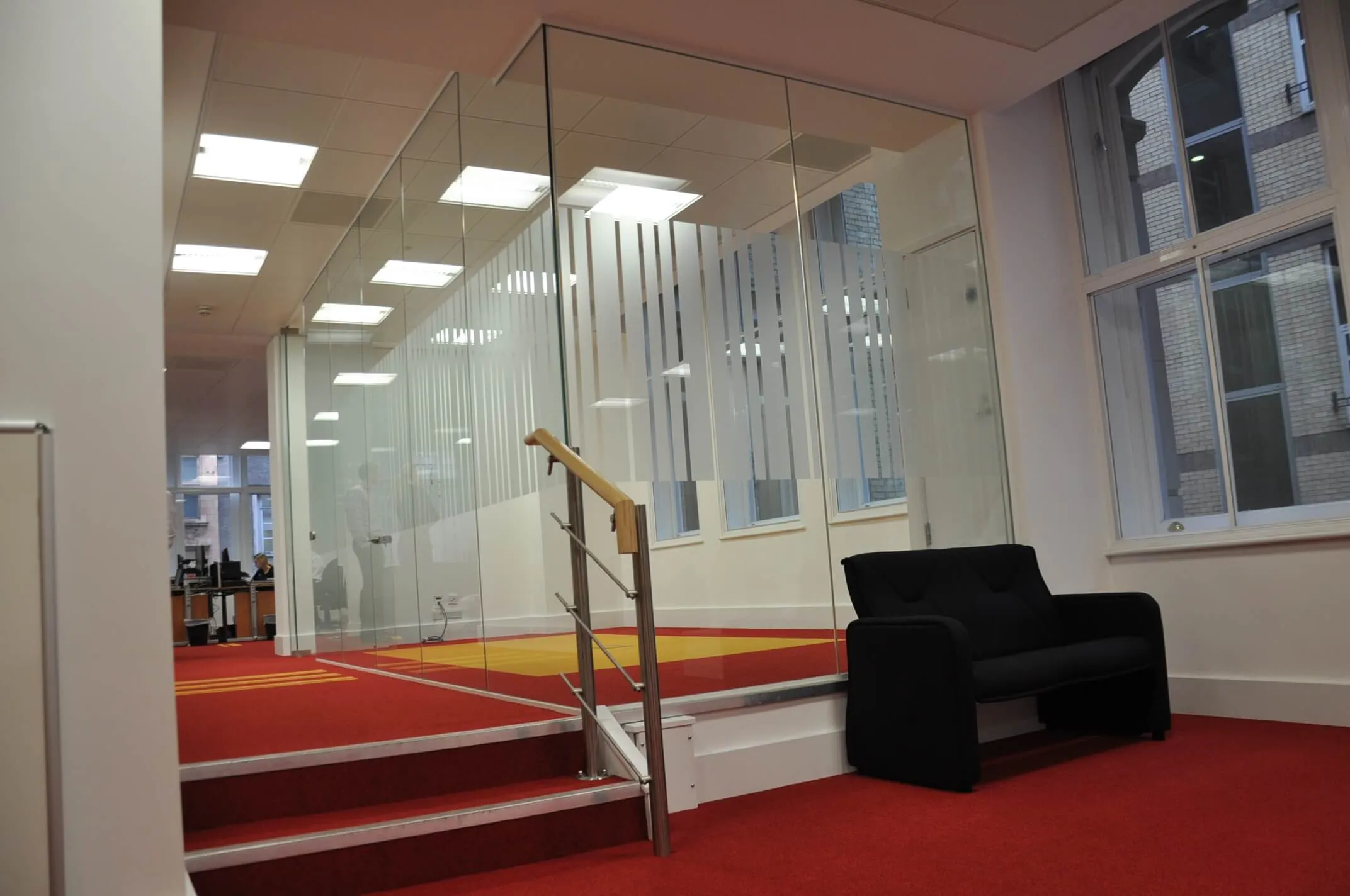 Small stairs sofa and glass partition with designer manifestation on it