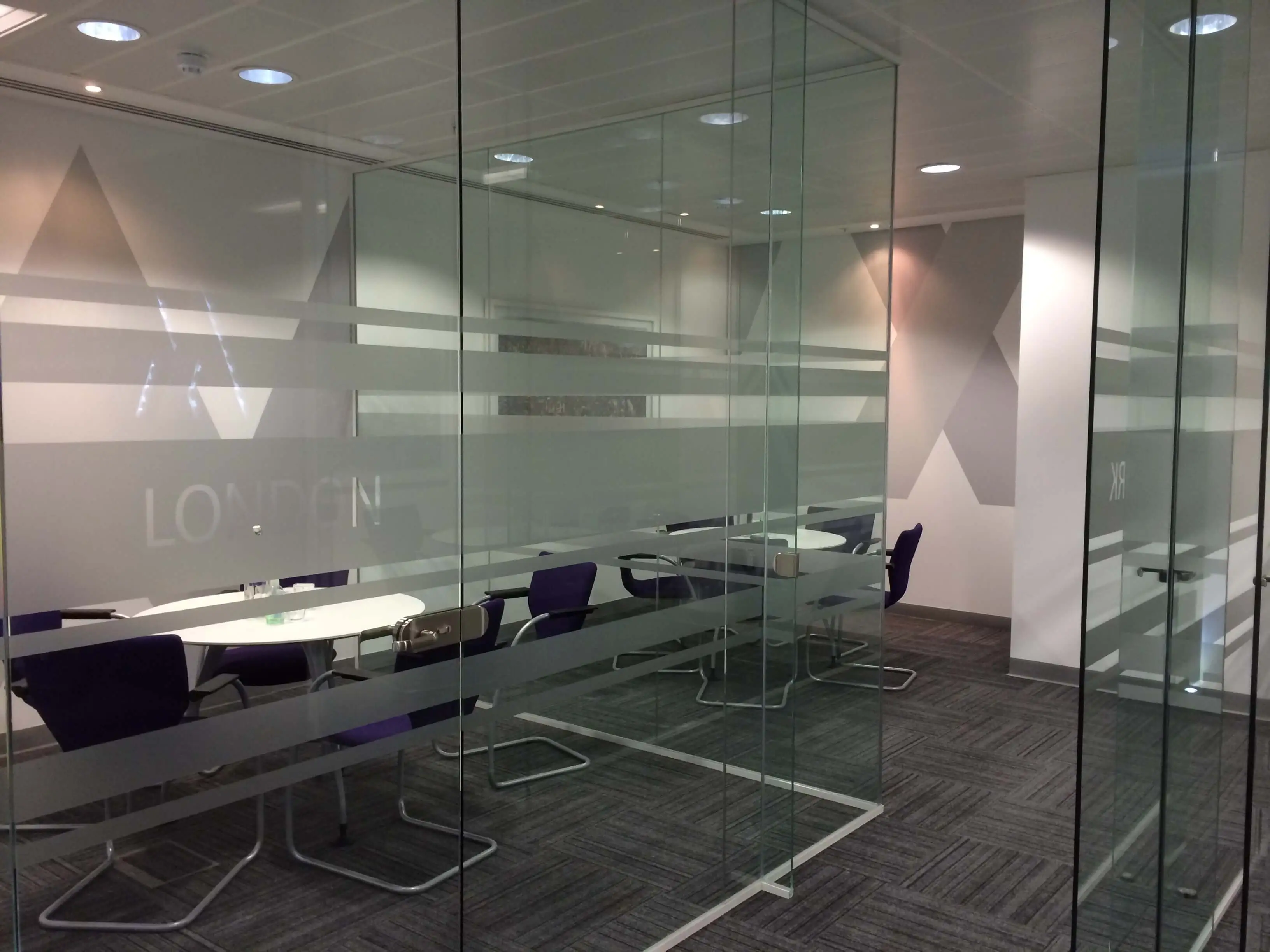 Two meeting area separated with glass partitions