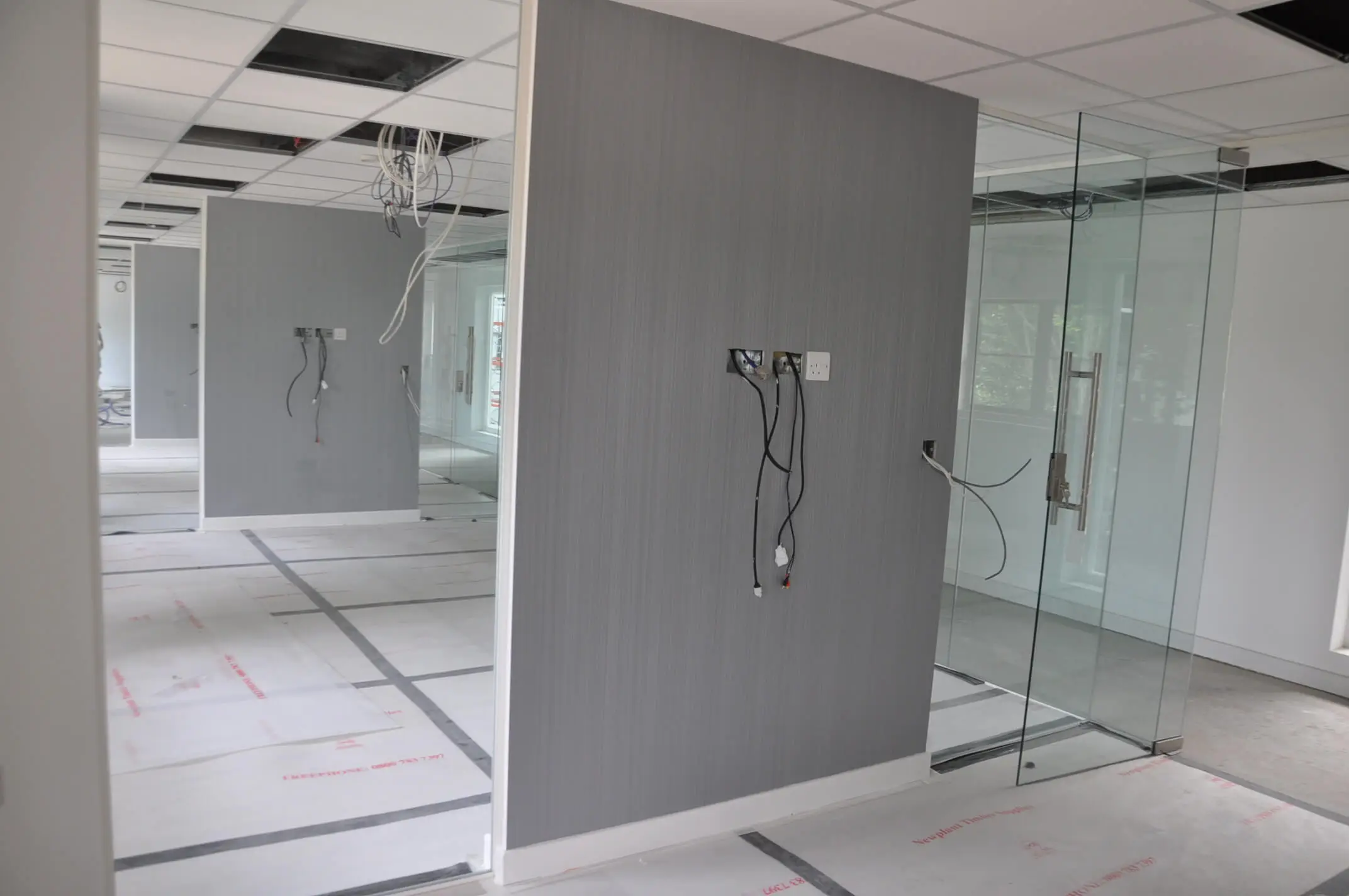 Work under construction of frameless glass partitioning