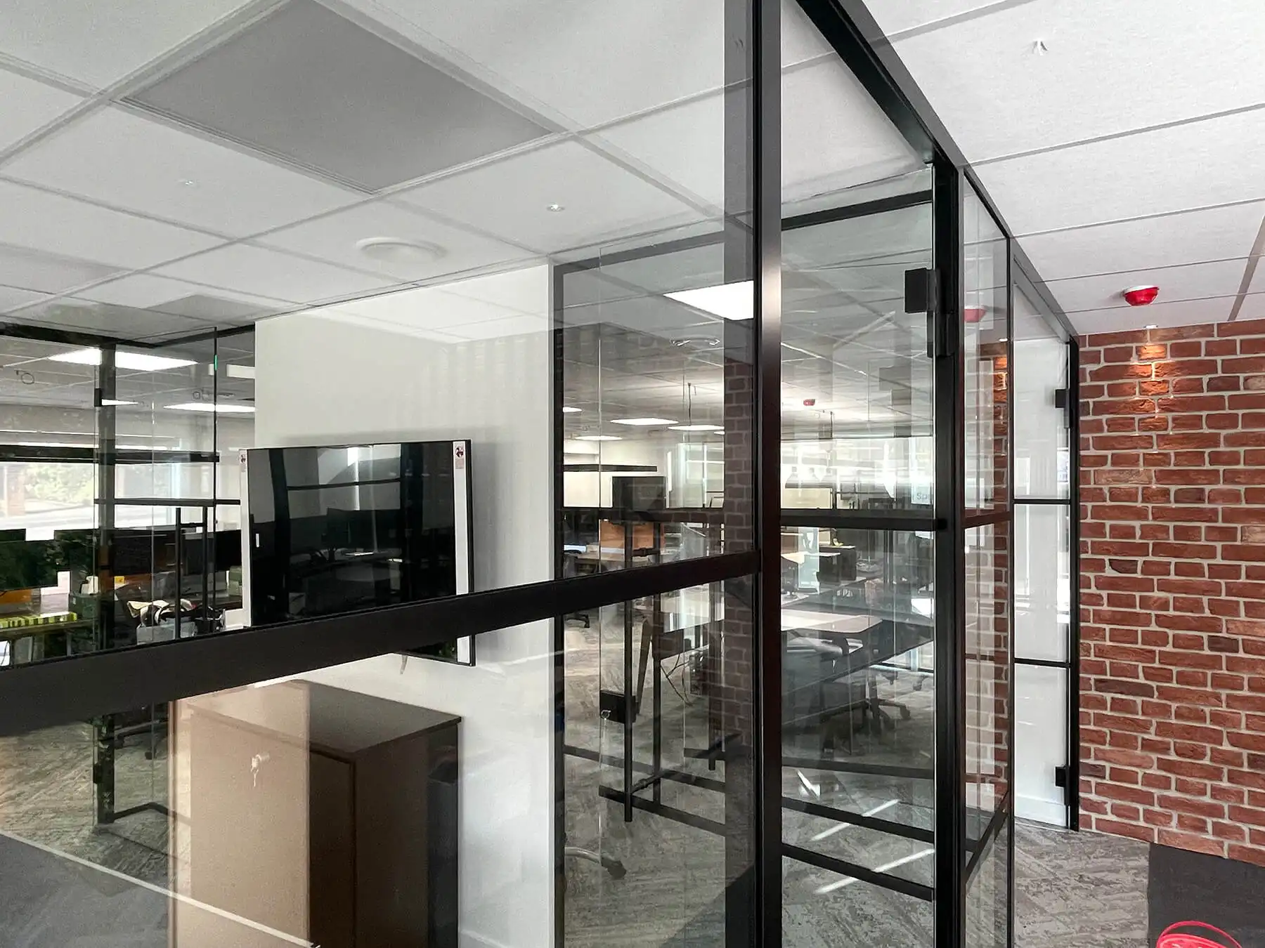 office space with designer furniture wall and glass partitions