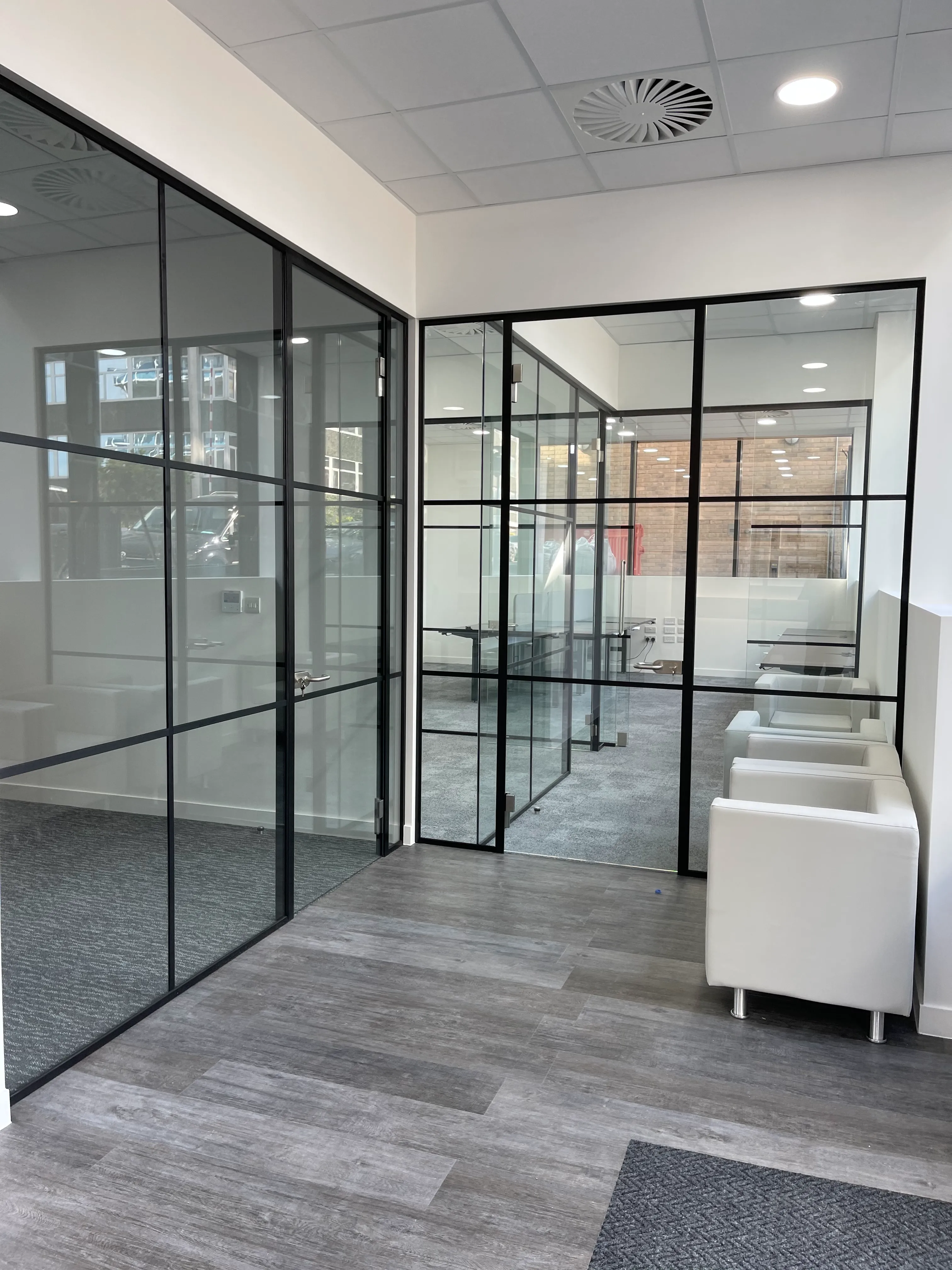 Breakout area with black framed glass partitions