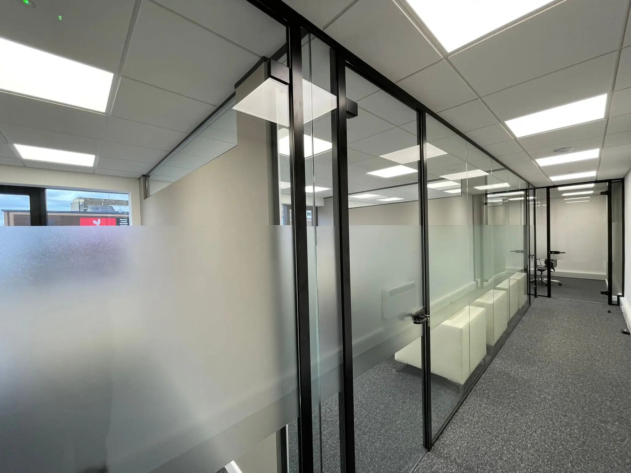 Designer floor office with single glazed partiton with framed doors