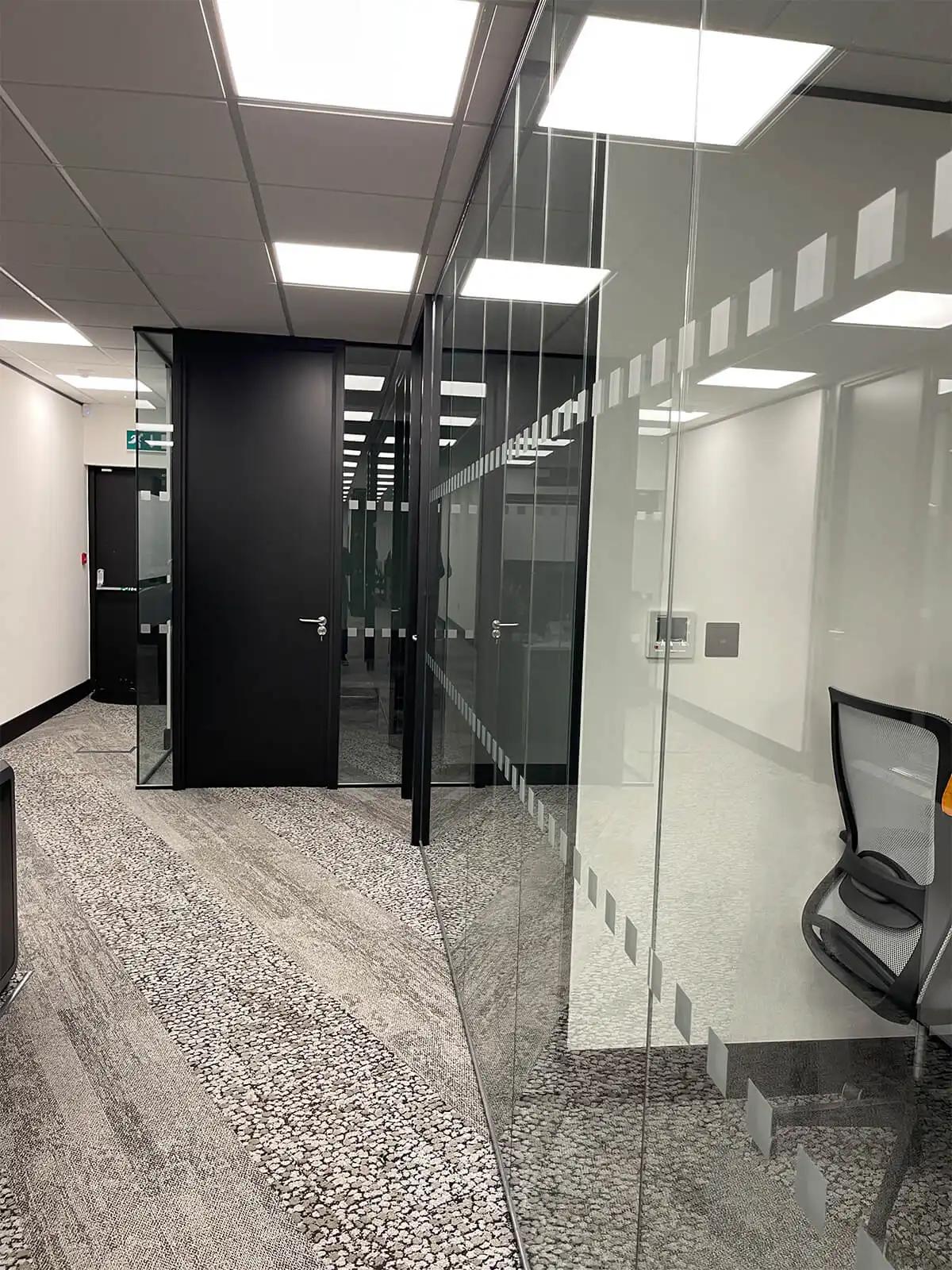 Dotted double glazes with solid doors partitions in office space partitions
