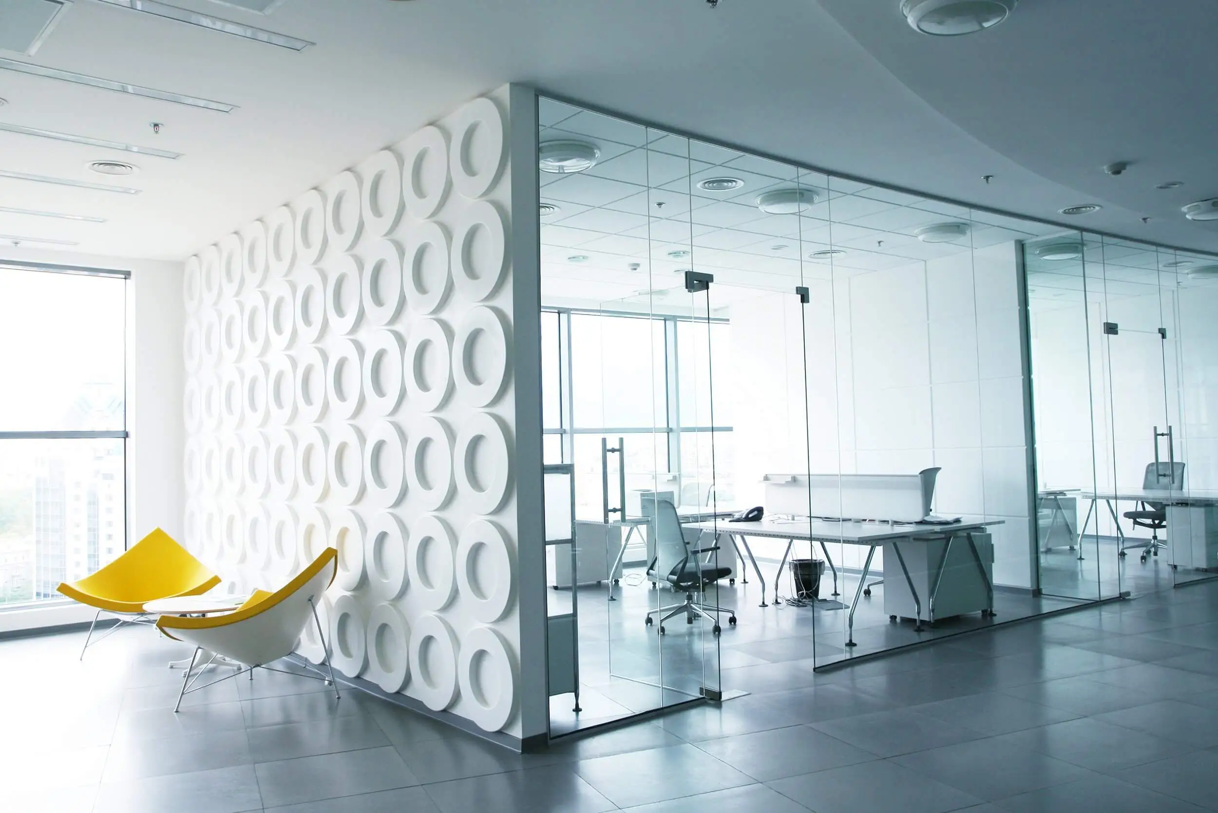Large office spaces divided with faceted glass walls
