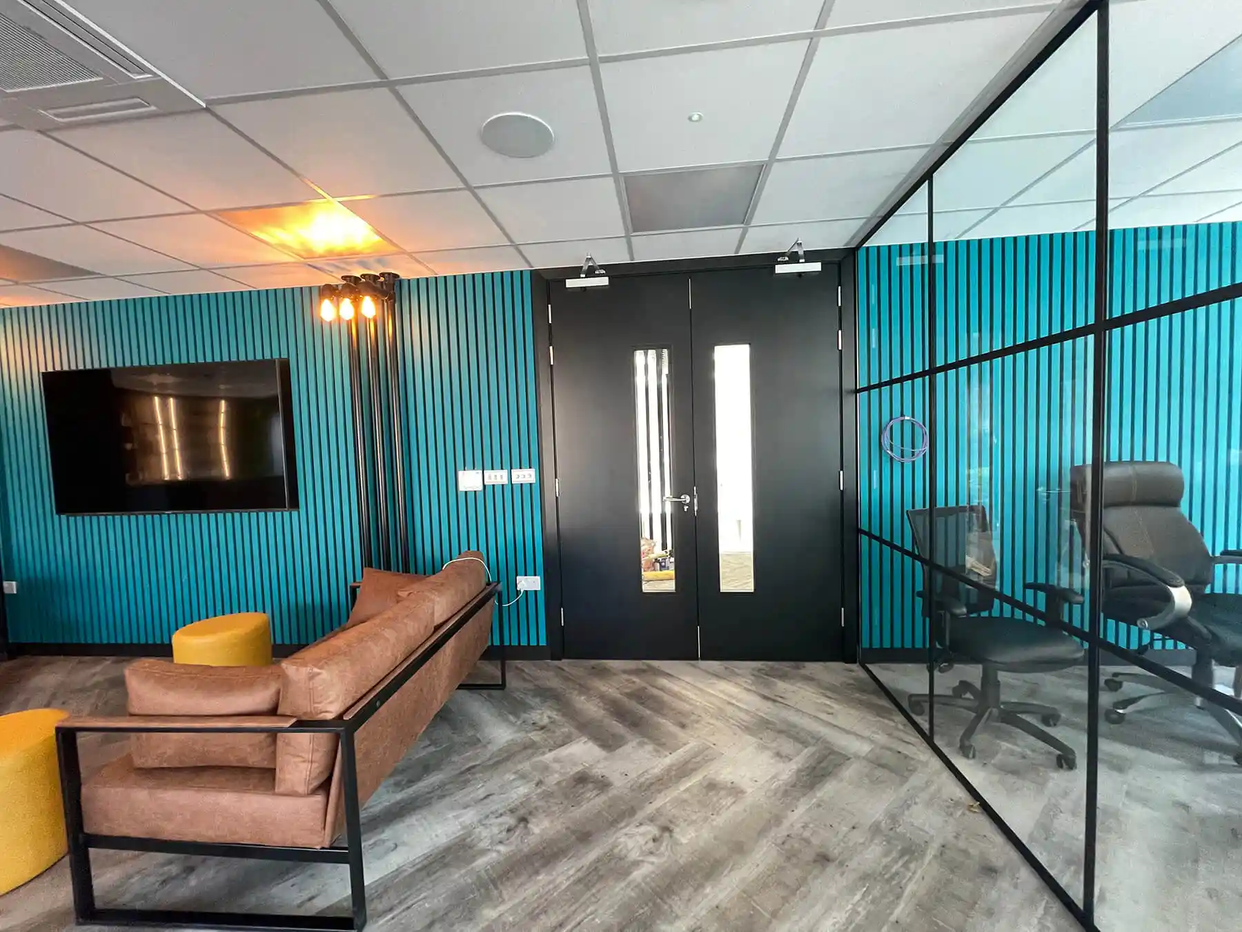 Modern office space with black framed glass doors