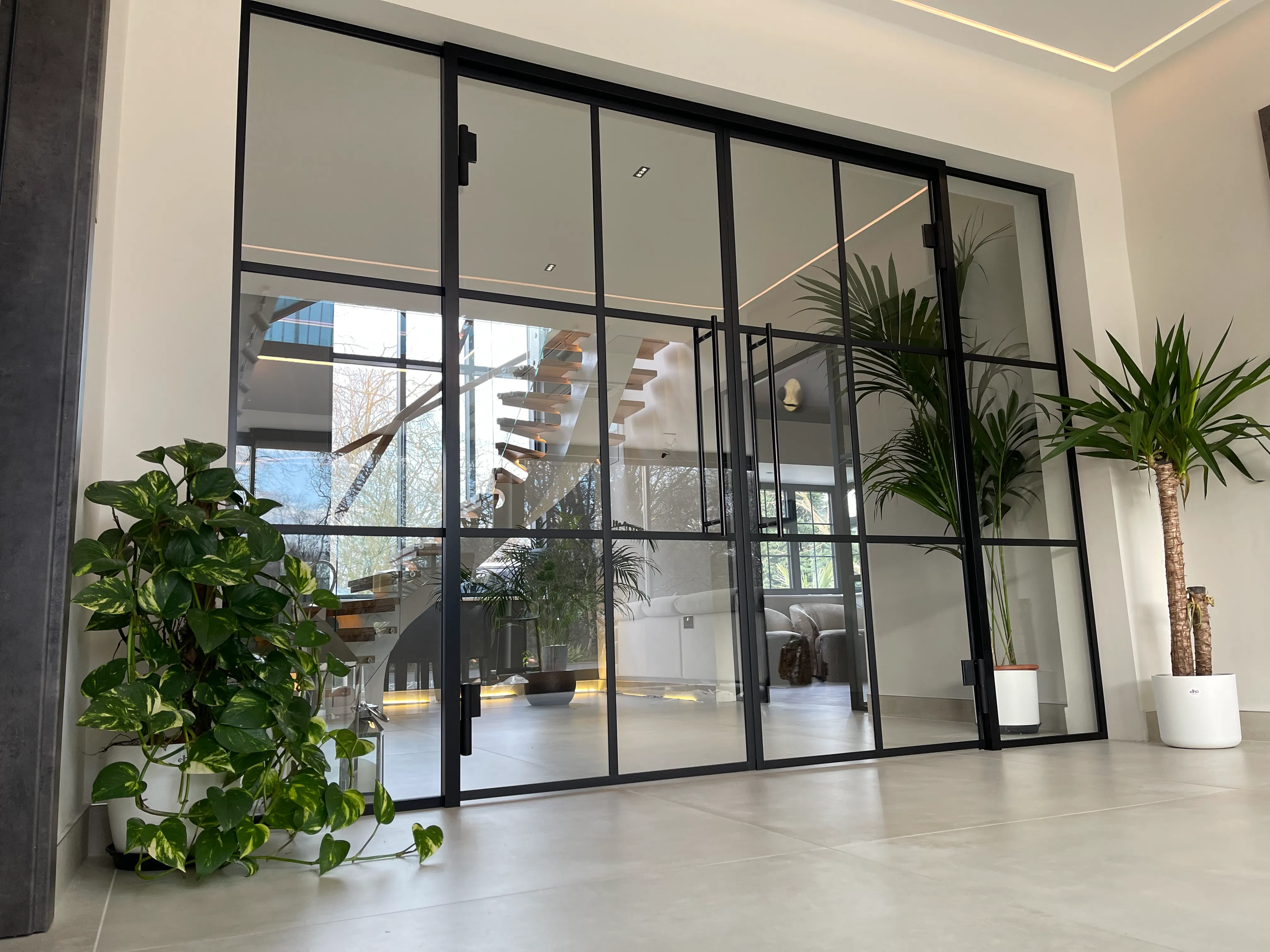 Office breakout and reception area with black framed glass partitions