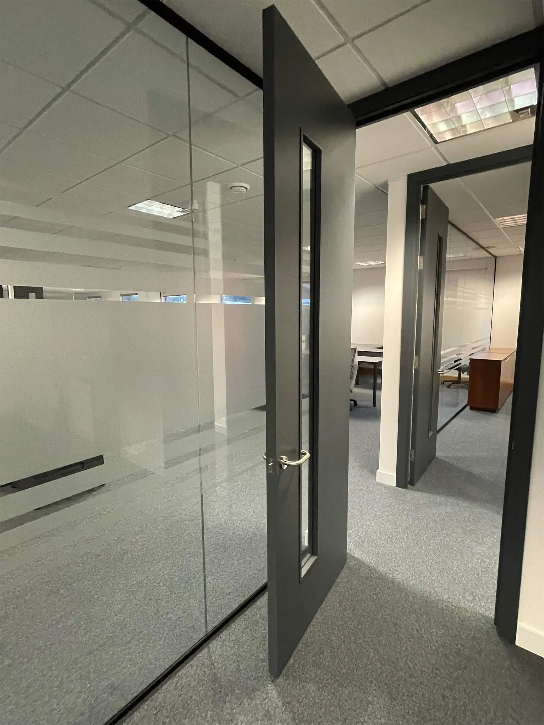 Office divided with single glaze partitions with solid doors