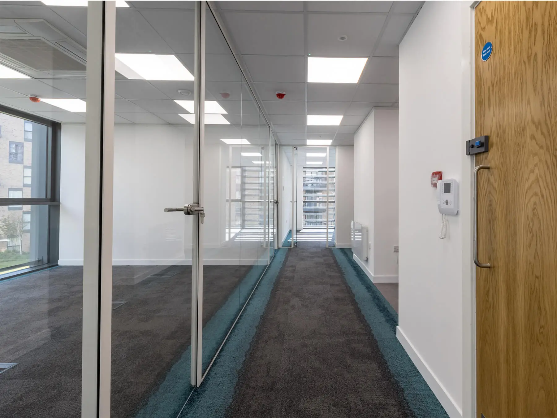 Office lobby with designer floors and single glazed partiton with framed doors