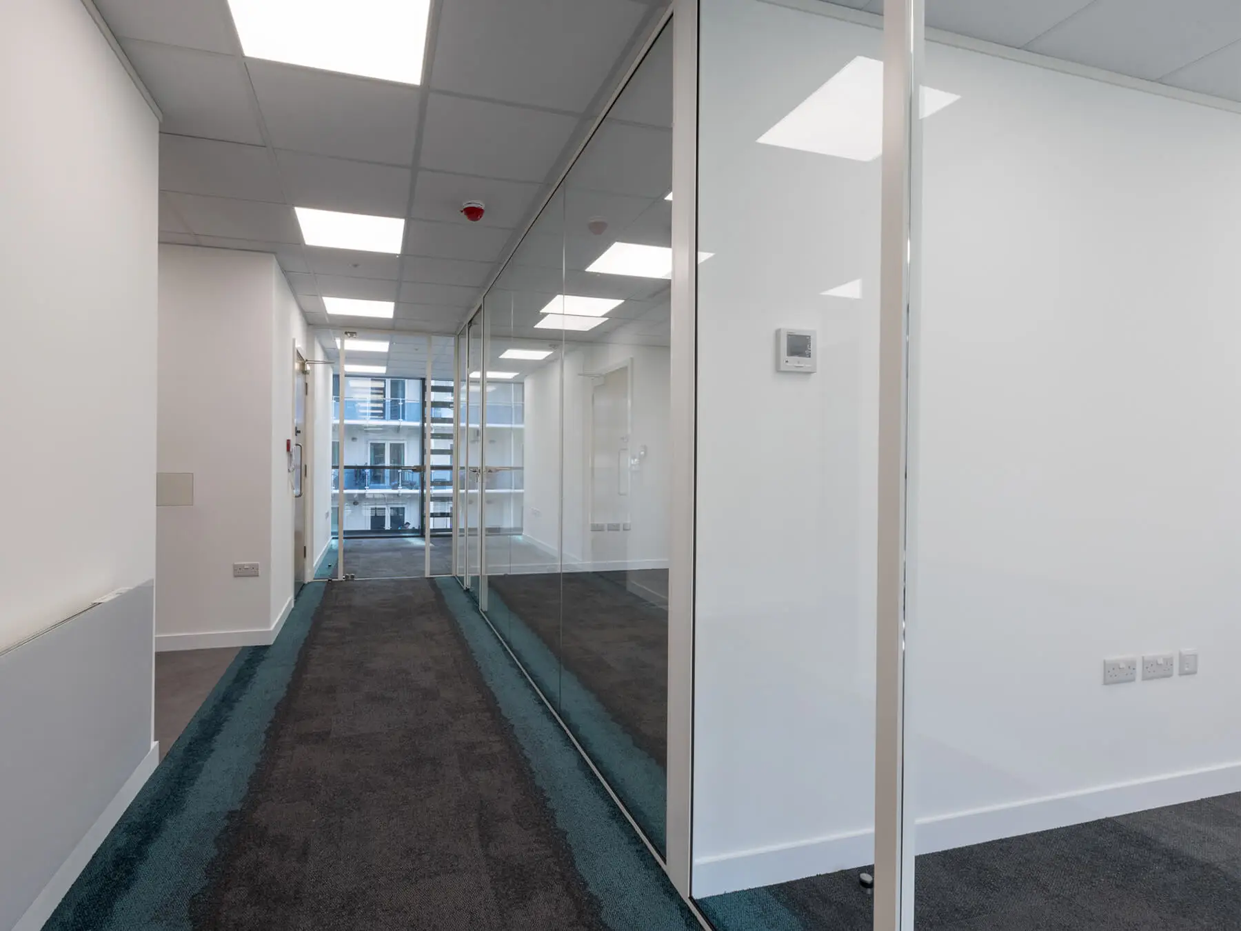 Office lobby with private space with single glazed partiton with framed doors