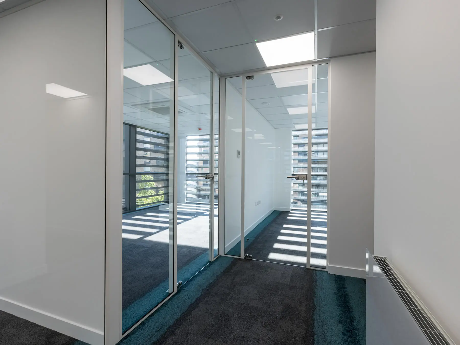 Office rooms with single glazed partiton with white framed doors