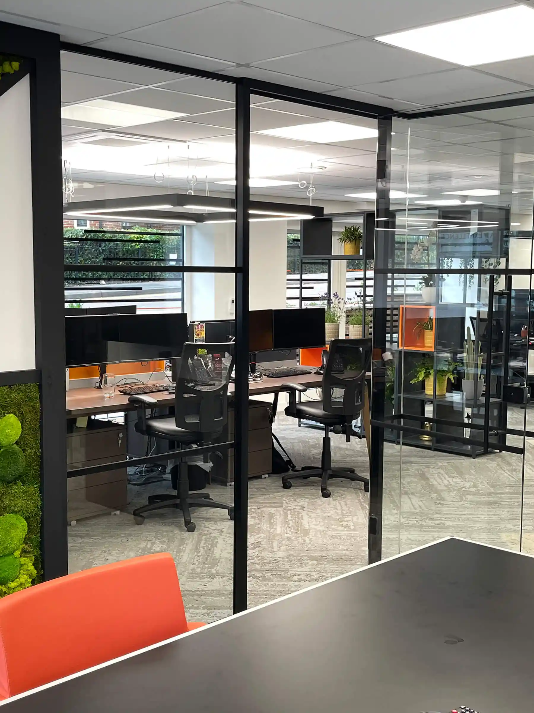 Office space divided with black framed glass doors