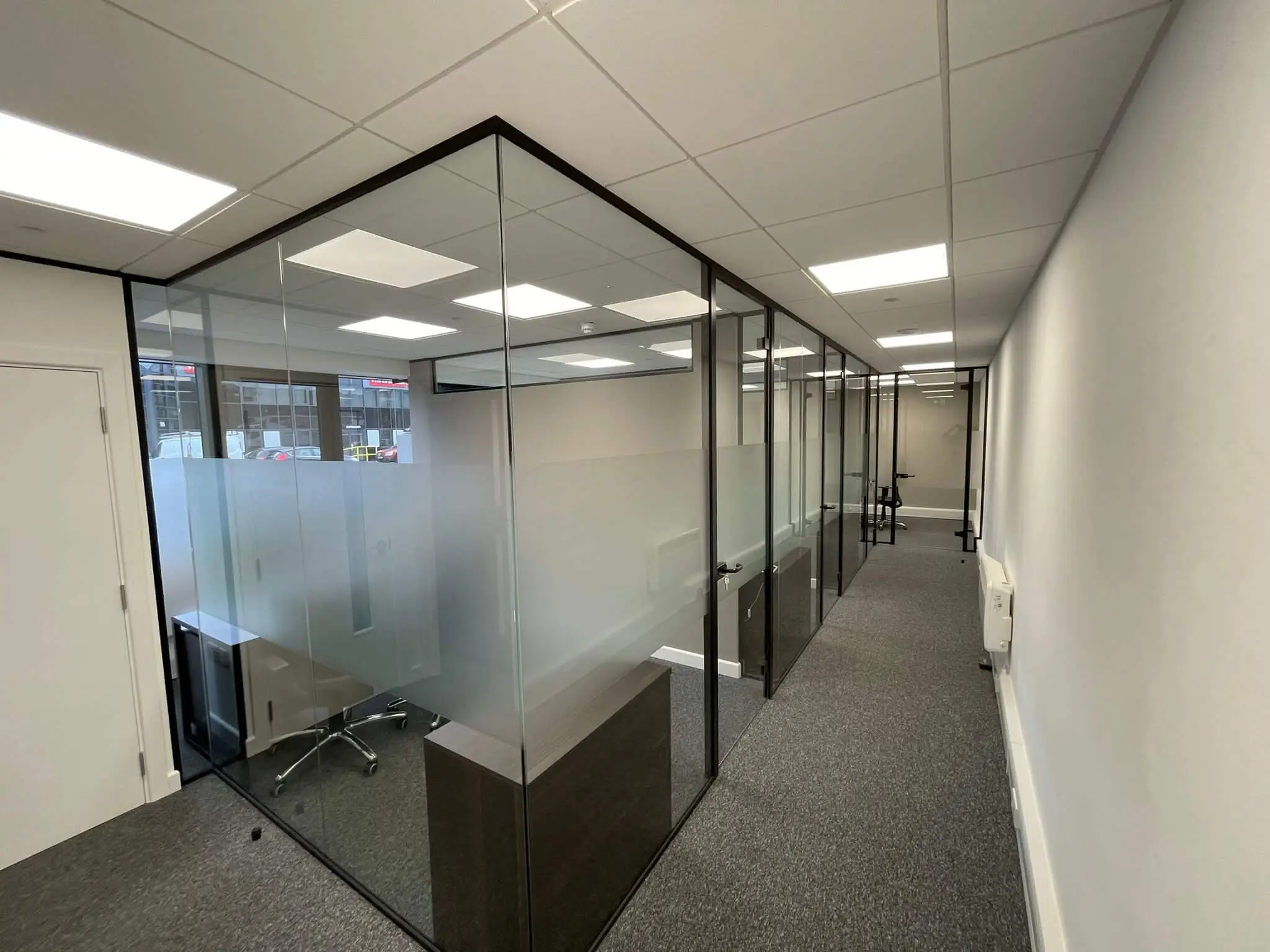 Office space divided with single glazed partiton with framed doors