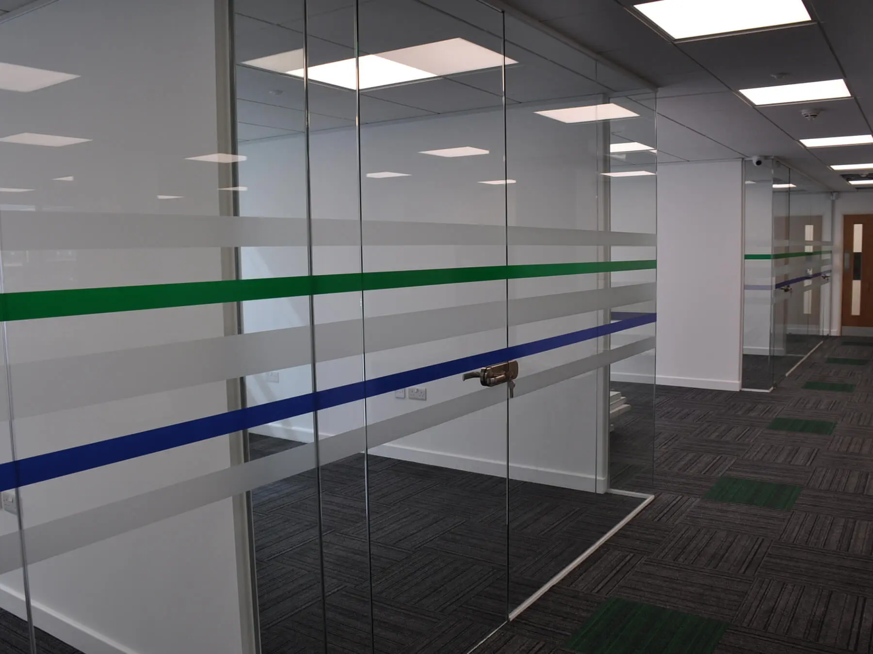 Office space with designer floor and single glazed frameless glass doors