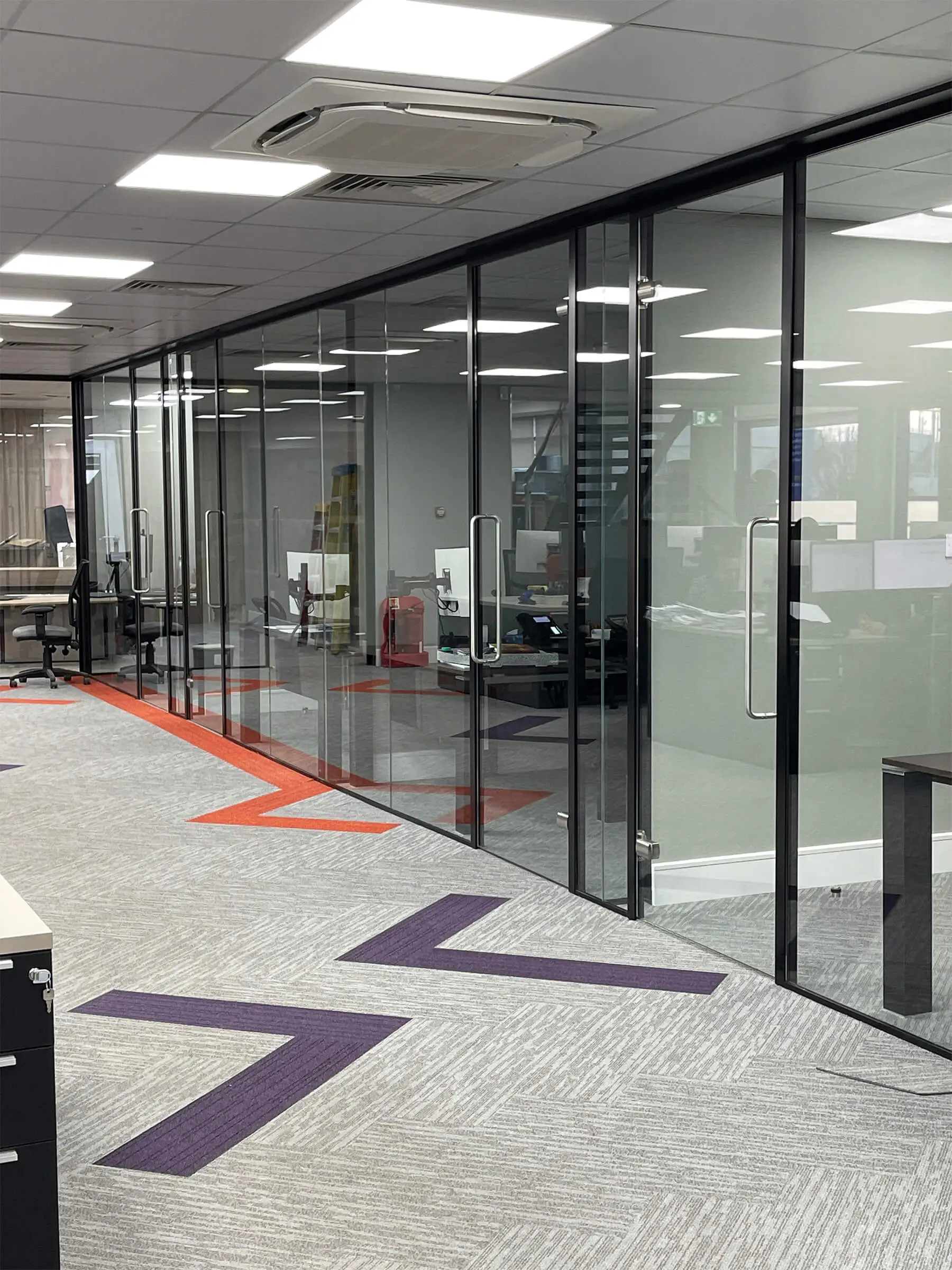 Office space with single glazed partiton with framed doors with full height handles