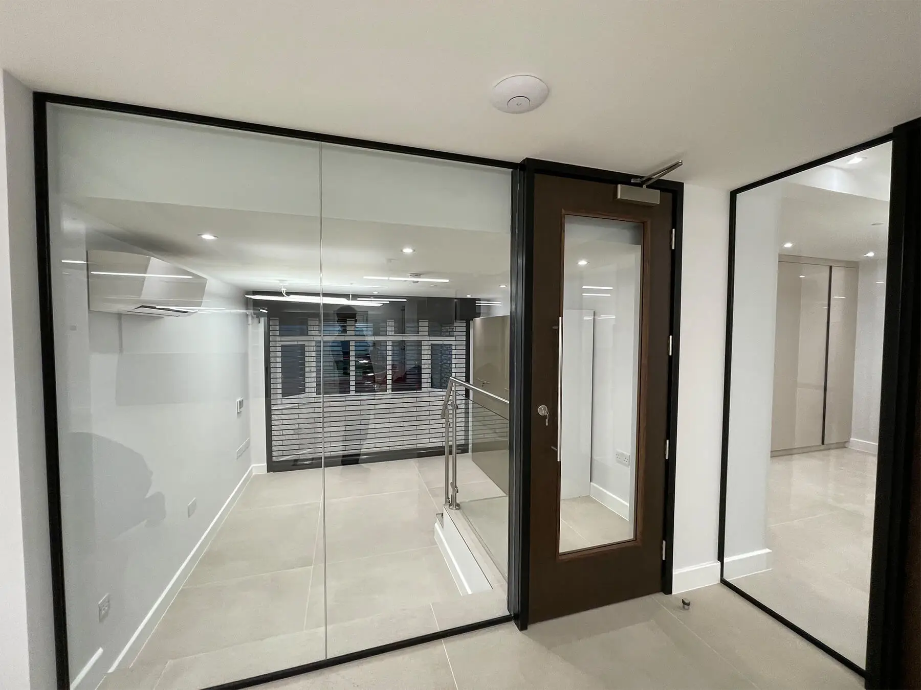 Office spaces divided with single glaze partitions with solid doors