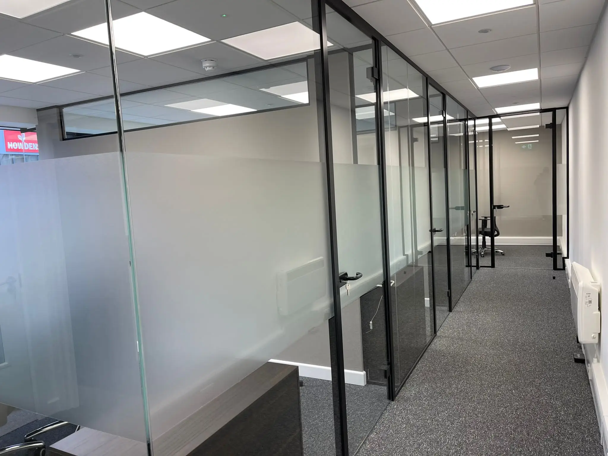 Office with designer floor and single glazed partiton with framed doors