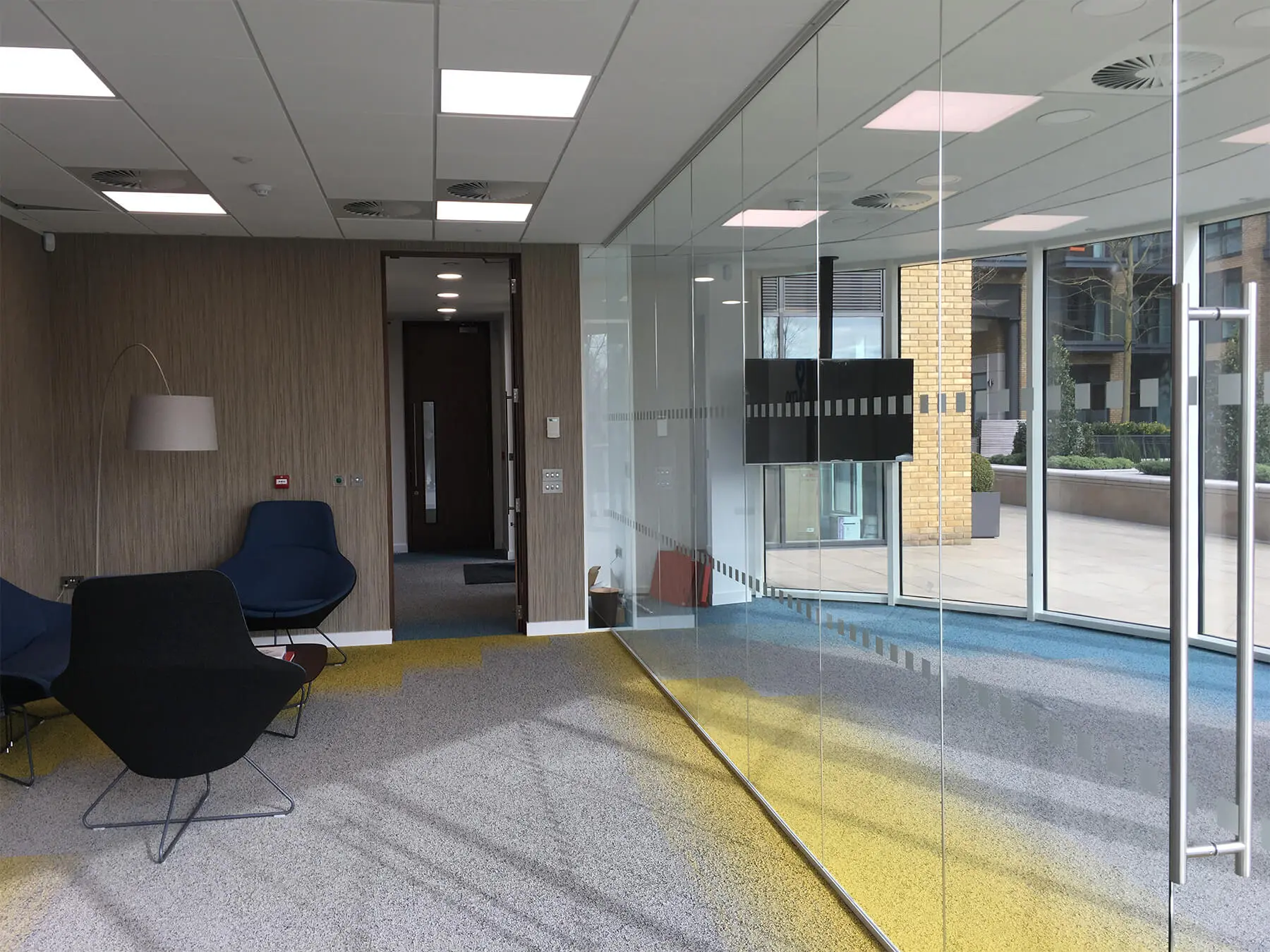 Office with sqaured doors on single glazed frameless glass doors
