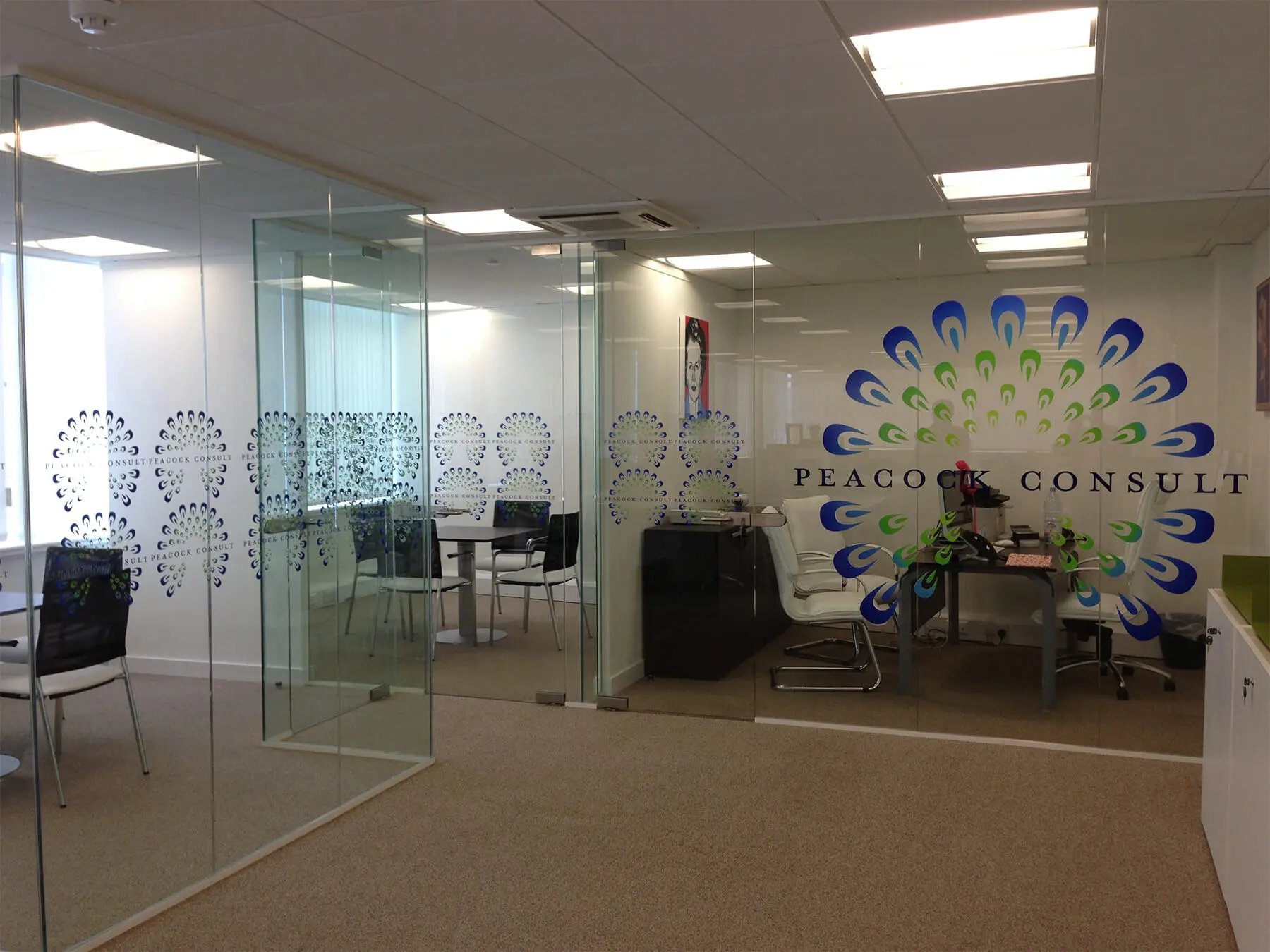 Single glazed frameless glass doors with logo cut out on it