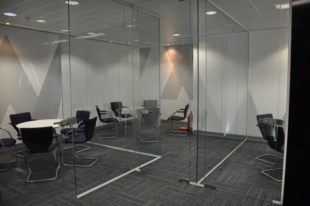 Small meeting space divided single glazed frameless glass doors